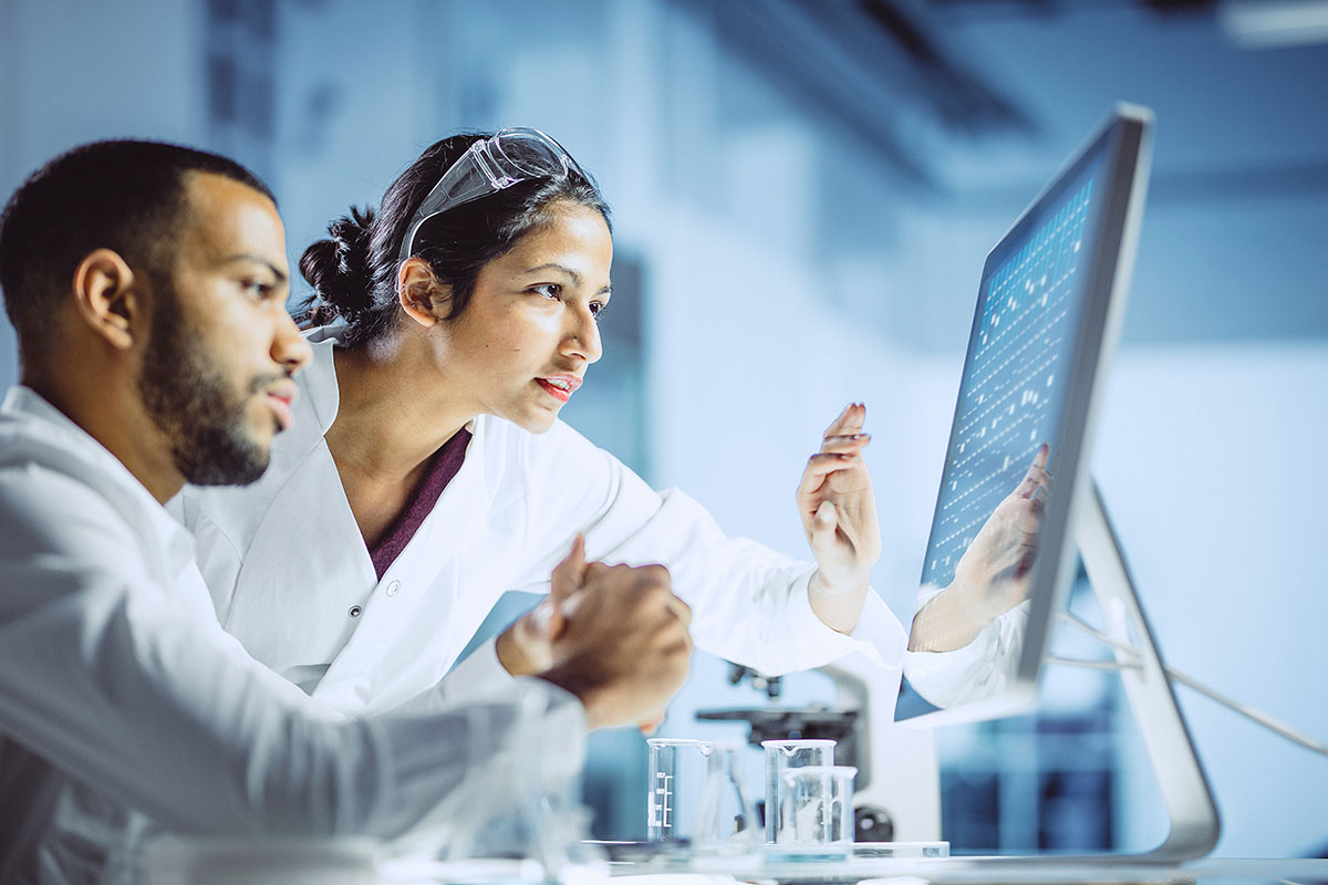 Two scientists observing a computer